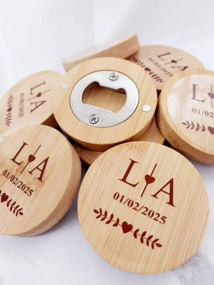 Round wooden bottle openers engraved with initials and an event date