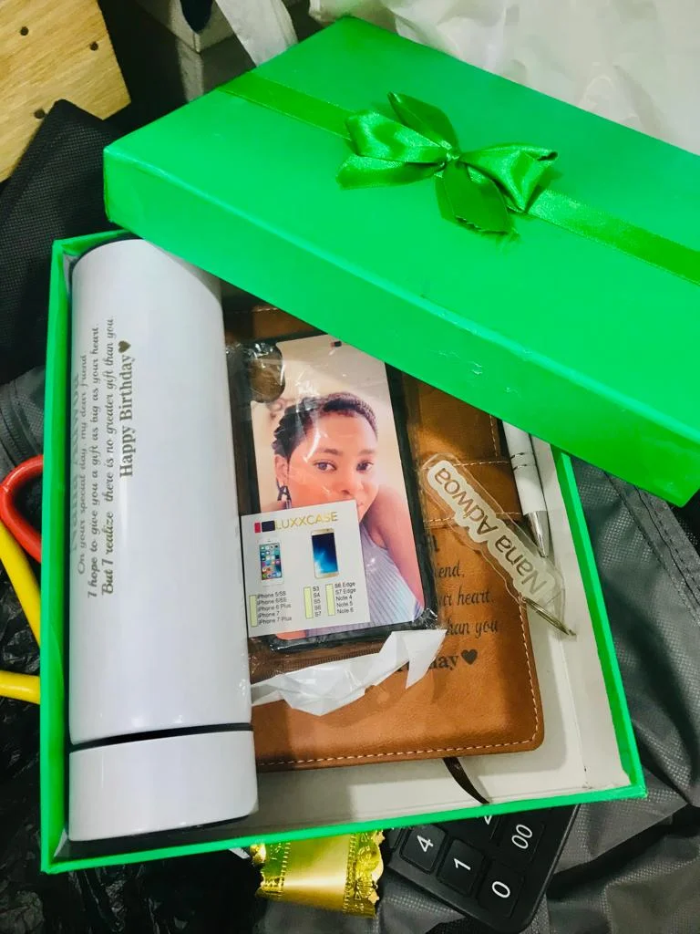 Green gift box with a white flask and personalised photo stationery