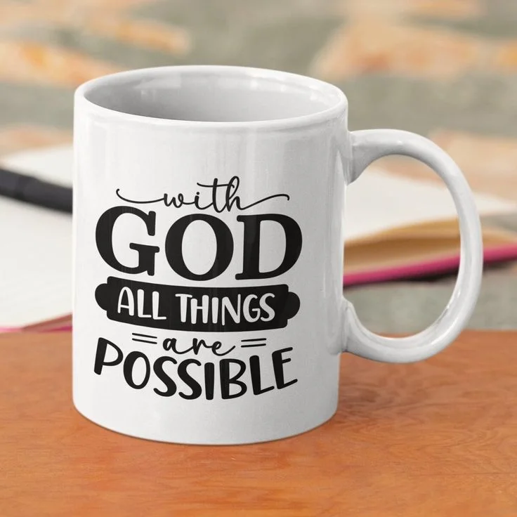 White ceramic mug printed with black script and block lettering