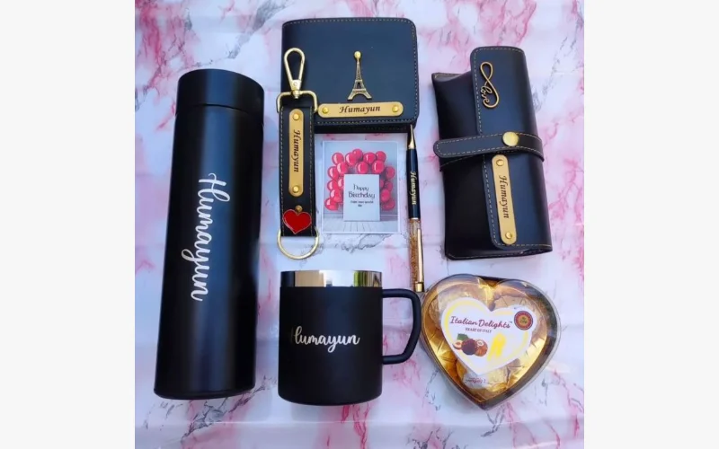 Black and gold personalised accessories with a flask, mug, keyring and notebook